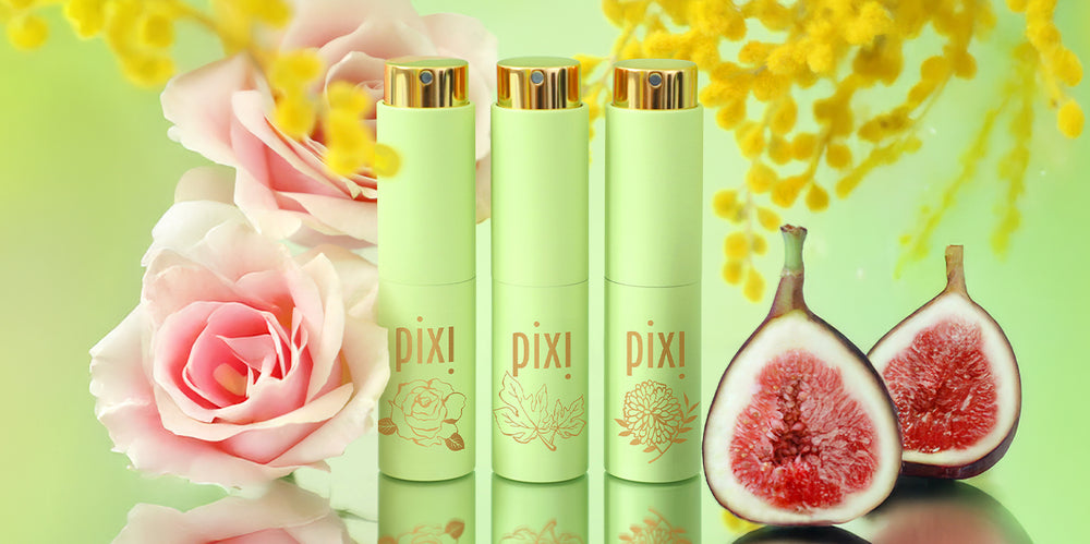 NEW PixiPerfume trio on a green background surrounded by roses, figs, and mimosa branches