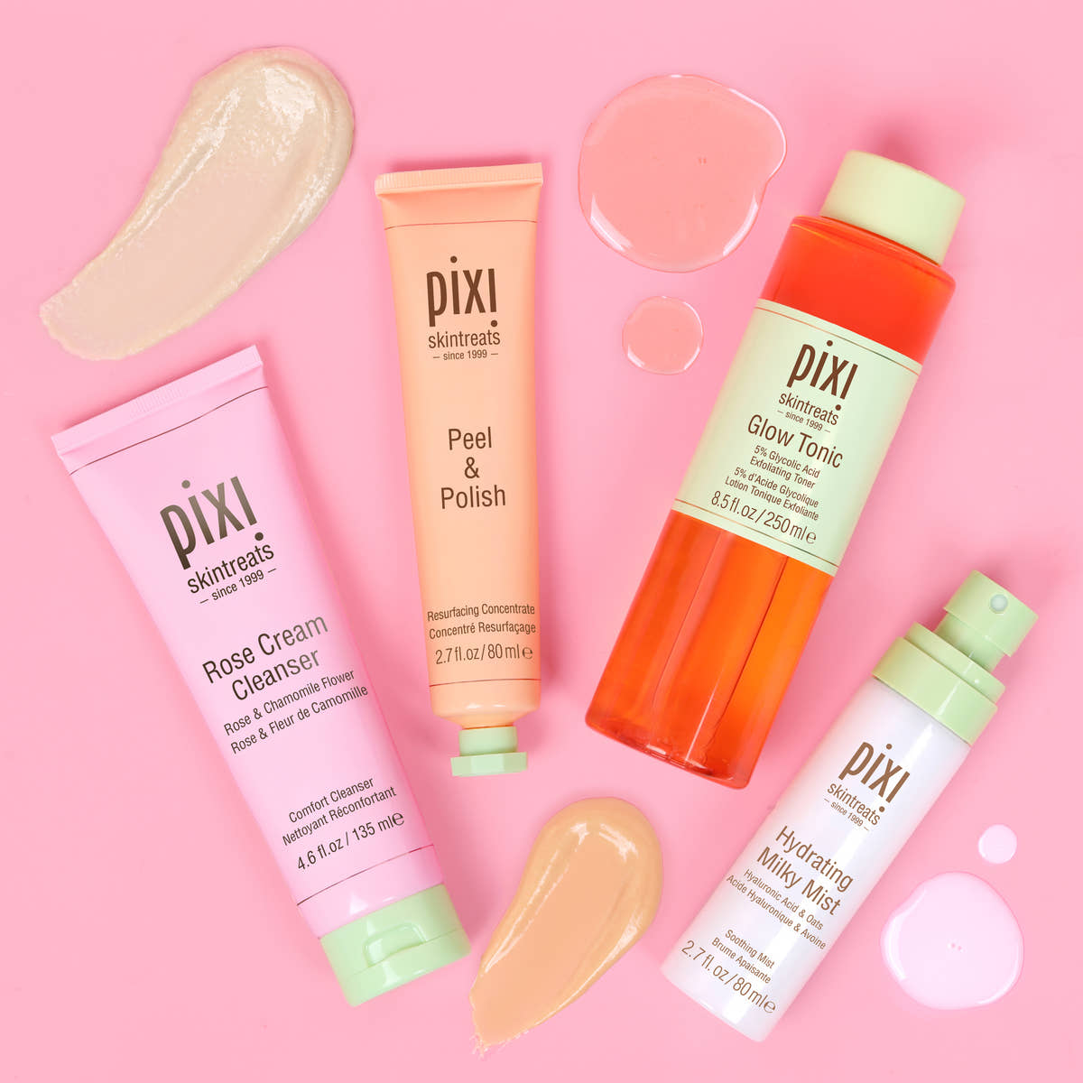 Pixi Glow Starter Routine skincare set arranged on a solid pink background: Rose Cream Cleanser in a pink tube, Peel & Polish in a peach tube, Hydrating Milky Mist in a white bottle with a mint cap, and Glow Tonic in an orange bottle with a pale green cap - top view with texture examples alongside each product.