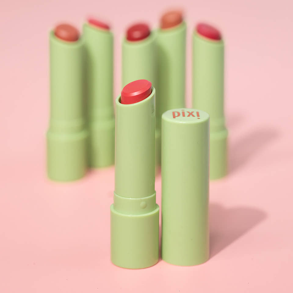 Pixi Naturelle lip balm with pink caps on a pink background view 1
